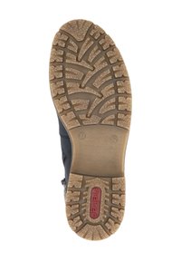 Semelle de botte noire avec un motif de grip en caoutchouc texturé, crampons de traction marron et marquage rouge. Taille indiquée comme 37.