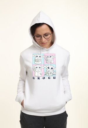 Bílá mikina s kapucí s předním potiskem zobrazujícím čtyři karikatury postavy "Grogu" obkreslené černou barvou, s multicolorovými akcenty.