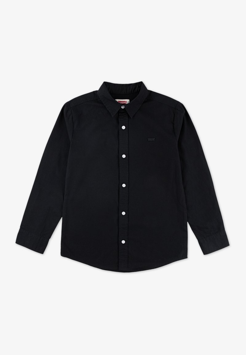 Chemise noire à manches longues avec boutons blancs, col pointu et petit logo discret sur la poitrine gauche.