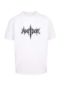 Hvid bomulds-t-shirt med et sort spidst grafisk tekstlogo "ANTIDOTE" i midten. Korte ærmer, rund hals, afslappet pasform.