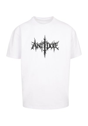 T-shirt bianco in cotone con un logo testuale grafico nero a punte "ANTIDOTE" al centro. Maniche corte, collo rotondo, vestibilità comoda.