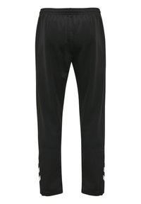 Zwarte sportbroeken met een elastische tailleband, taps toelopende benen en witte chevronaccenten aan de zijkanten. Gemaakt van een gladde, lichte stof.