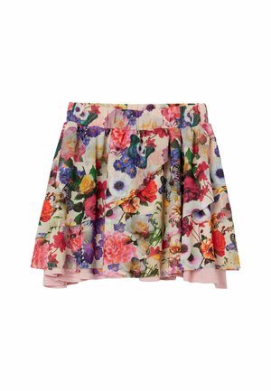 Jupe courte fleurie avec des roses colorées, des marguerites et des papillons sur un tissu à couches et à volants avec un jupon rose clair.