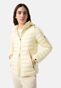 Yellow puffer jacket with a zippered front, hood, and side pockets. Features a quilted design and elasticized cuffs. Smooth, shiny texture.