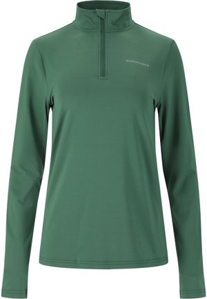 Långärmad topp med kvartdragkedja i mörkgrön tyg. Innehåller hög krage och diskret logotypdetalj, slät textur och figursydd design.