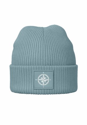 Knitted beanie in soft blue color, featuring a ribbed texture and a foldable cuff with a compass graphic on a square patch.