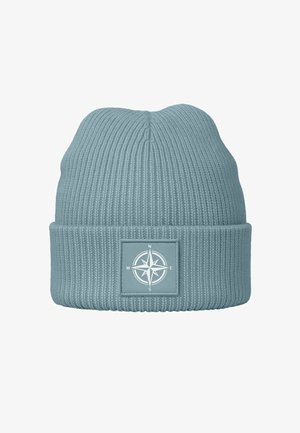 Knitted beanie in soft blue color, featuring a ribbed texture and a foldable cuff with a compass graphic on a square patch.