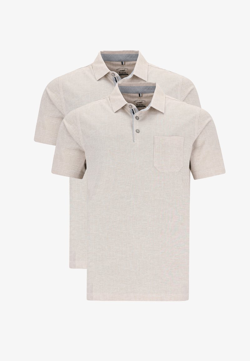 Två beige kortärmade polo skjortor med ficka, med knapplist och en subtil strukturerad tyg.