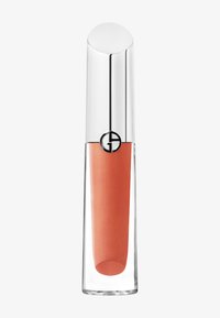 En klar glass leppestift tube med en sølvhette, som inneholder en ferskenfarget glans. Hetten har en rund svart logo.