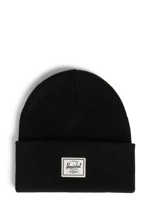 Black knit beanie with a folded cuff, featuring a rectangular white brand patch on the front. Soft texture, snug fit, and simple design.