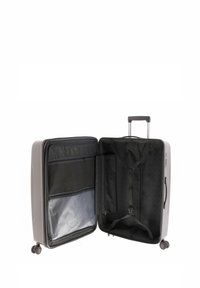 Grau hartschalige Reisetasche mit einem ausziehbaren Griff. Das Innere verfügt über eine schwarze Stoffauskleidung, eine Reißverschlusstasche und Kompressionsgurte zur Organisation.