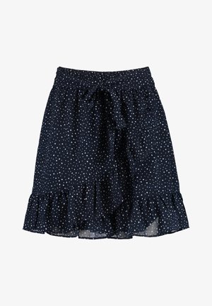 Falda azul marino con lunares blancos, cintura elástica con lazo, dobladillo con volantes y tela ligera con una textura suave.