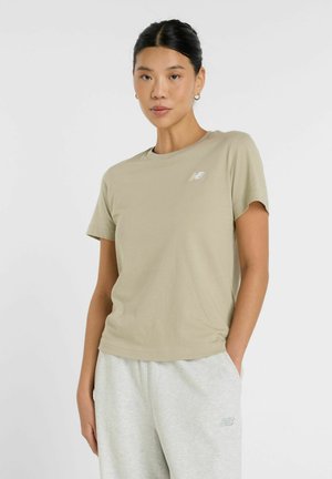 Beige cotton t-shirt with a crew neckline and short sleeves. Features a small white logo on the chest. Smooth texture.