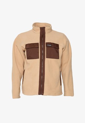 Chaqueta de forro polar beige con ribete marrón en la cremallera, dos bolsillos marrones en el pecho con solapas y un pequeño logo rectangular de Columbia en el bolsillo izquierdo del pecho.