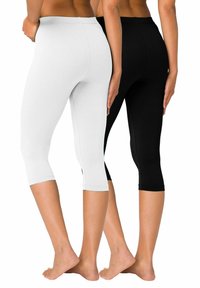 Leggings capri noir et blanc en tissu doux et extensible, avec une taille lisse et une coupe ajustée, atteignant le milieu du mollet.
