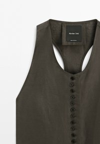 Dark olive green sleeveless vest with ten black buttons down the front and a Massimo Dutti label sewn inside the collar.