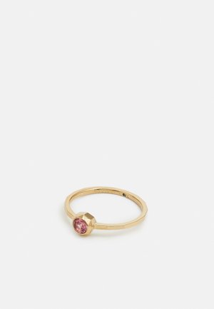 Gold ring with a faceted pink gemstone set in a geometric bezel on a thin, polished band against a white background.