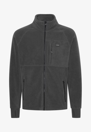 Siva flis jakna s uspravnim ovratnikom, punim zatvaranjem, dva bočna džepa, džepom na prsima i elastičnim manžetama. Ima detalj s logotipom na prsima.