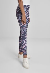 Leggings sa tamnom mornarskom osnovom s ružičastim i bijelim tie-dye uzorkom. Izrađene su od rastezljivog materijala, s prilagođenim dizajnom i dužinom do gležnja.