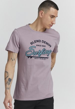 Svijetloplavi pamučni majica s okruglim izrezom. Ima grafički otisak koji uključuje "Blend Denim" i "Surfing" u kontrastnim bojama.