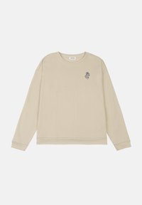 Beige sweatshirt with crew neckline, dropped shoulders, and ribbed cuffs. Features a small black graphic print on the left chest.