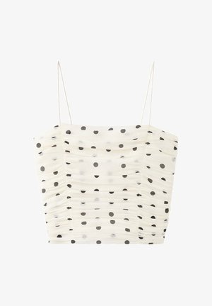Crop top blanc froncé avec fines bretelles et motif à pois noirs répartis uniformément sur le tissu.