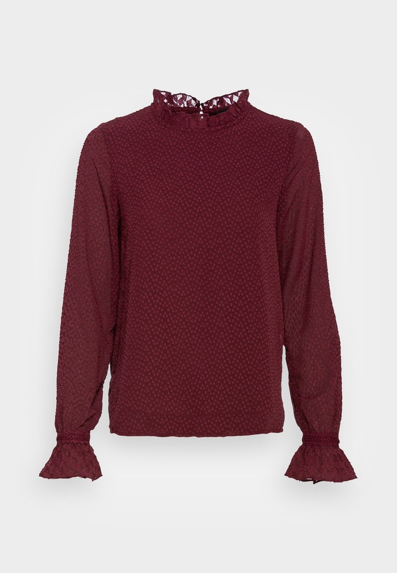 Blouse bordeaux à manches longues en tissu texturé, col haut volanté et poignets volantés.
