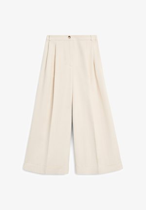 Høj talje, brede ben, cremefarvede bukser med en frontplissering, bæltestropper og lukning med knap i taljen.