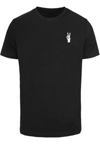 Sort bomulds T-shirt med rund hals, korte ærmer og et hvidt grafisk fredstegn på venstre brystområde.
