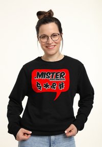 Felpa nera con una grande grafica a forma di fumetto rosso contenente testo e simboli in bianco e nero bold. Tessuto morbido e casual.