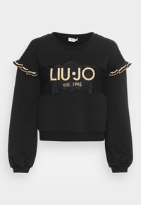 Sudadera negra corta con mangas largas abullonadas. Presenta texto en glitter dorado "LIU·JO est. 1995" y detalle de encaje negro con bordes rizados.