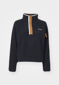 Pull en polaire bleu marine avec design à demi-zip. Comprend une patte de boutonnage marron, un col blanc et une poche poitrine zippée.