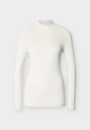 Bela majica z dolgimi rokavi iz gladkega, raztegljivega materiala. Ima visok ovratnik in raglanske rokave z minimalnimi detajli šivov.