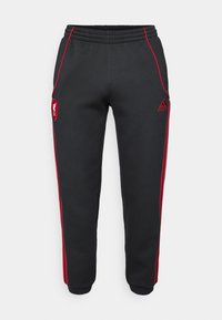 Schwarze Jogginghose mit roten Seitenstreifen, elastischem Bund und Liverpool FC-Logo. Hergestellt aus einem glatten, weichen Material.