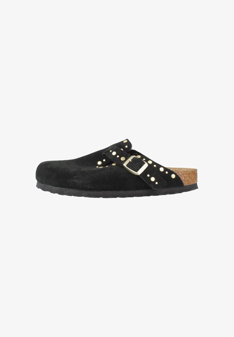 Black suede clog with cork sole, featuring an adjustable strap with gold buckle and gold studs along the strap and upper edge.
