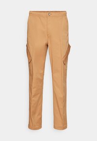 Pantalon cargo beige avec une taille élastique, doté de deux poches latérales et d'une coupe décontractée. Fabriqué en tissu de coton durable.