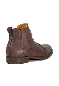 Brown leather ankle boots featuring a round toe, lace-up front, and a pull tab at the back. Smooth texture with a mid-height heel.