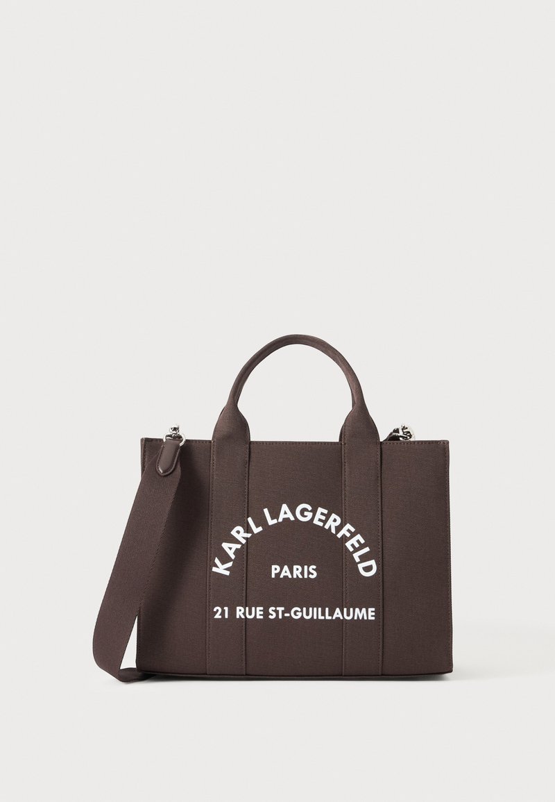 Кафява чанта тип тоут Karl Lagerfeld Paris с две дръжки, сваляща се презрамка за рамо и бял надпис „21 Rue St-Guillaume“.