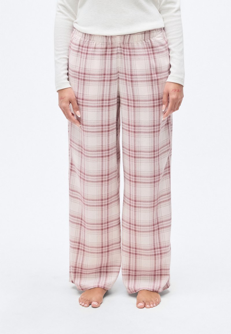 Ελαφριά καρό παντελόνια με ελαστική μέση. Τα χρώματα περιλαμβάνουν απαλό μπεζ και κόκκινο. Φαρδιά εφαρμογή με φαρδιές παντελόνες και λεία υφή.