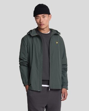 Lightweight green jacket with a hood, elastic cuffs, and front zipper. Features a small gold logo on the chest and a smooth texture.