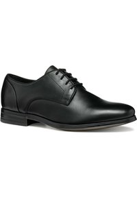 Scarpe da uomo in pelle nera con una finitura liscia e elegante. Presentano una punta arrotondata, una chiusura con lacci e un design minimalista. Tacco basso impilato.