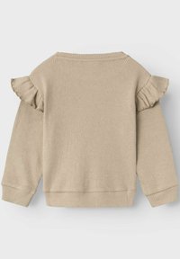 Felpa beige a coste con dettagli a volants sulle maniche, scollatura rotonda e polsini a coste. Tessuto morbido, vestibilità casual.