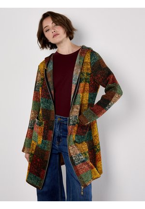 Manteau long multicolore à carreaux avec capuche, deux poches avant et fermeture éclair à l'avant. Confectionné dans un tissu texturé aux tons chauds.