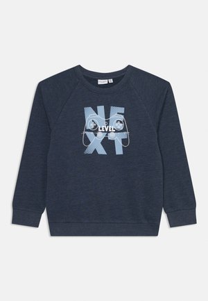 Sweatshirt bleu marine avec manches raglan longues et col rond. La face avant présente un texte graphique en blanc et bleu clair avec des manettes de jeu.