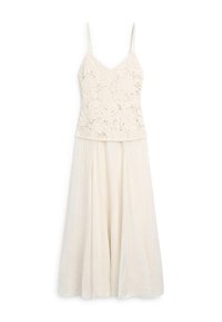 Ärmelloses cremefarbenes Kleid mit einem Spitzen bestickten Oberteil und einem fließenden, plissierten Rock unterhalb der Taille.