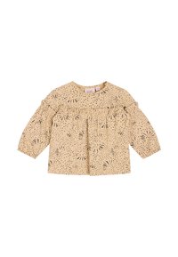 Camicia beige con maniche lunghe a sbuffo, caratterizzata da motivi a piccoli punti neri e rouches lungo il davanti. Collo rotondo, tessuto leggero.