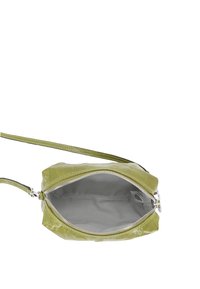 Green patent leather bag with a zip closure, featuring a smooth texture and lined interior. Includes a slim shoulder strap.