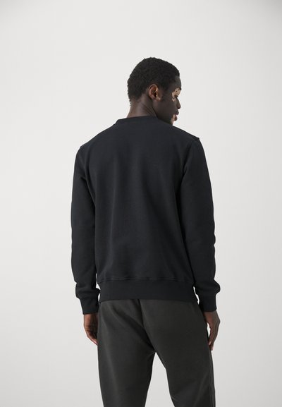 Black sweatshirt with a round neck, ribbed cuffs, and hem. Made from soft material, featuring a smooth texture and relaxed fit.