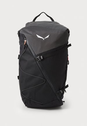 Zaino nero con un design geometrico, realizzato in tessuto resistente, presenta una cerniera curva, spallacci regolabili e una maniglia superiore per un trasporto facile.
