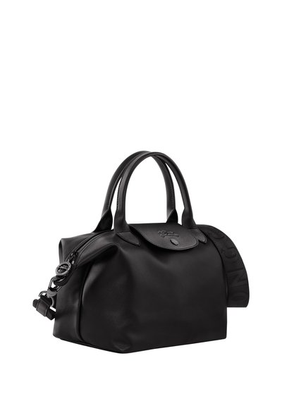 Black leather handbag with a rounded shape, dual short handles, and an adjustable shoulder strap. Features a smooth texture and subtle branding.